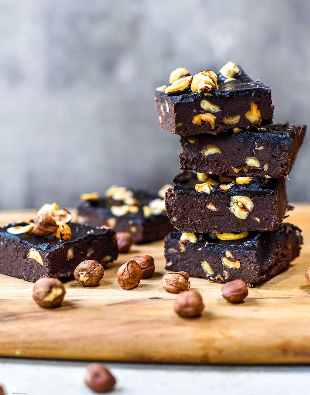 fudgey brownies stacked with hazelnuts