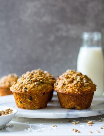 side view of morning glory muffins with milk in background