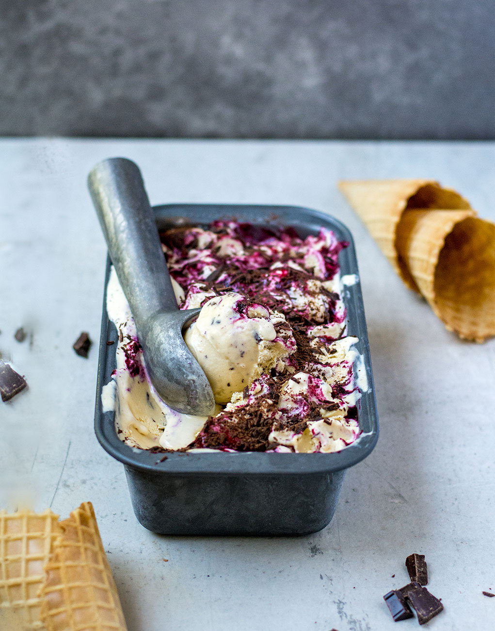black currant ice cream with cones and scoop side photo
