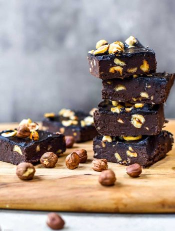 fudgey brownies stacked with hazelnuts