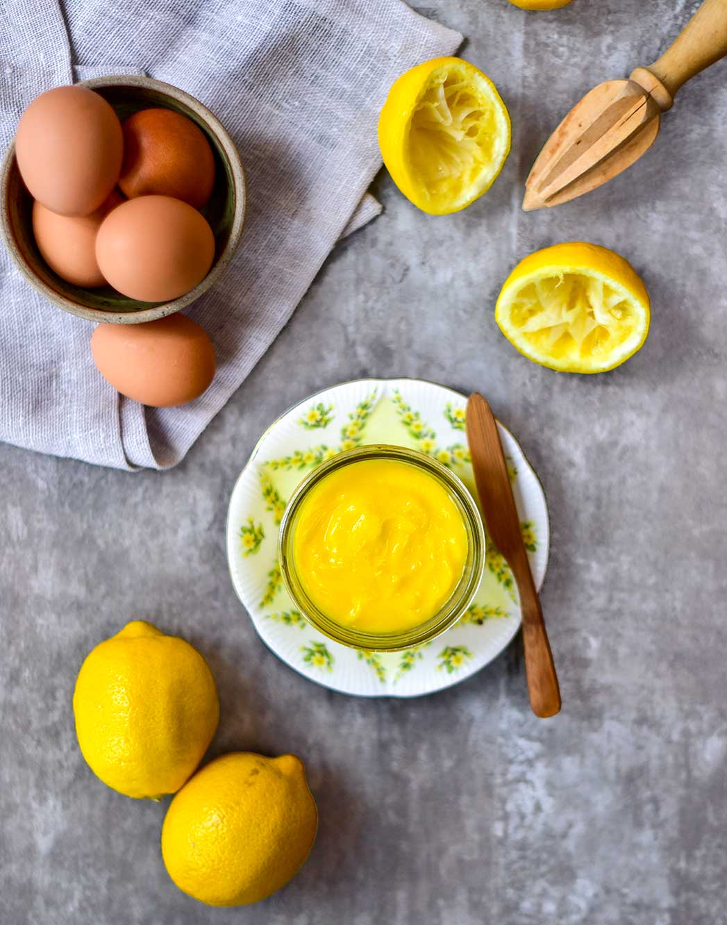 lemon curd with lemons and eggs on table