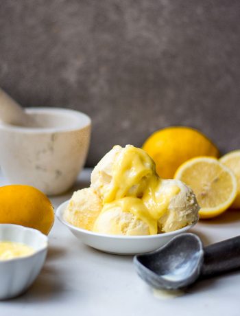 lemon curd ice cream in bowl with ice cream scoop