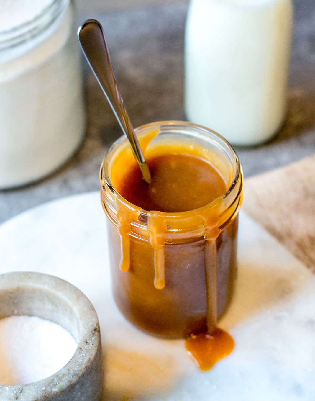 caramel sauce in glass jar dripping down sides